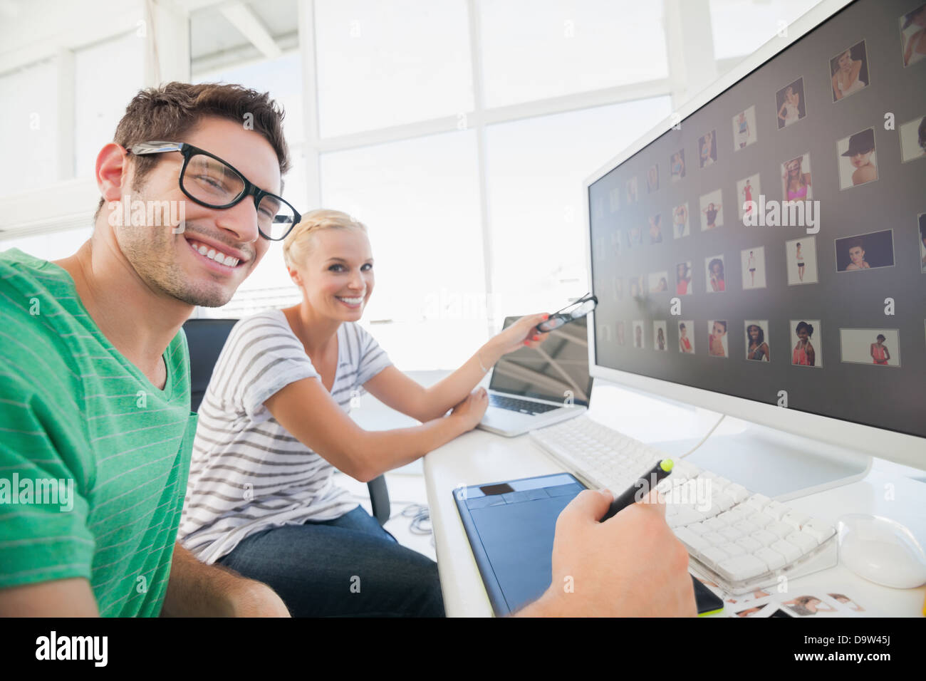 Cheerful photo editors working on photograph Stock Photo - Alamy