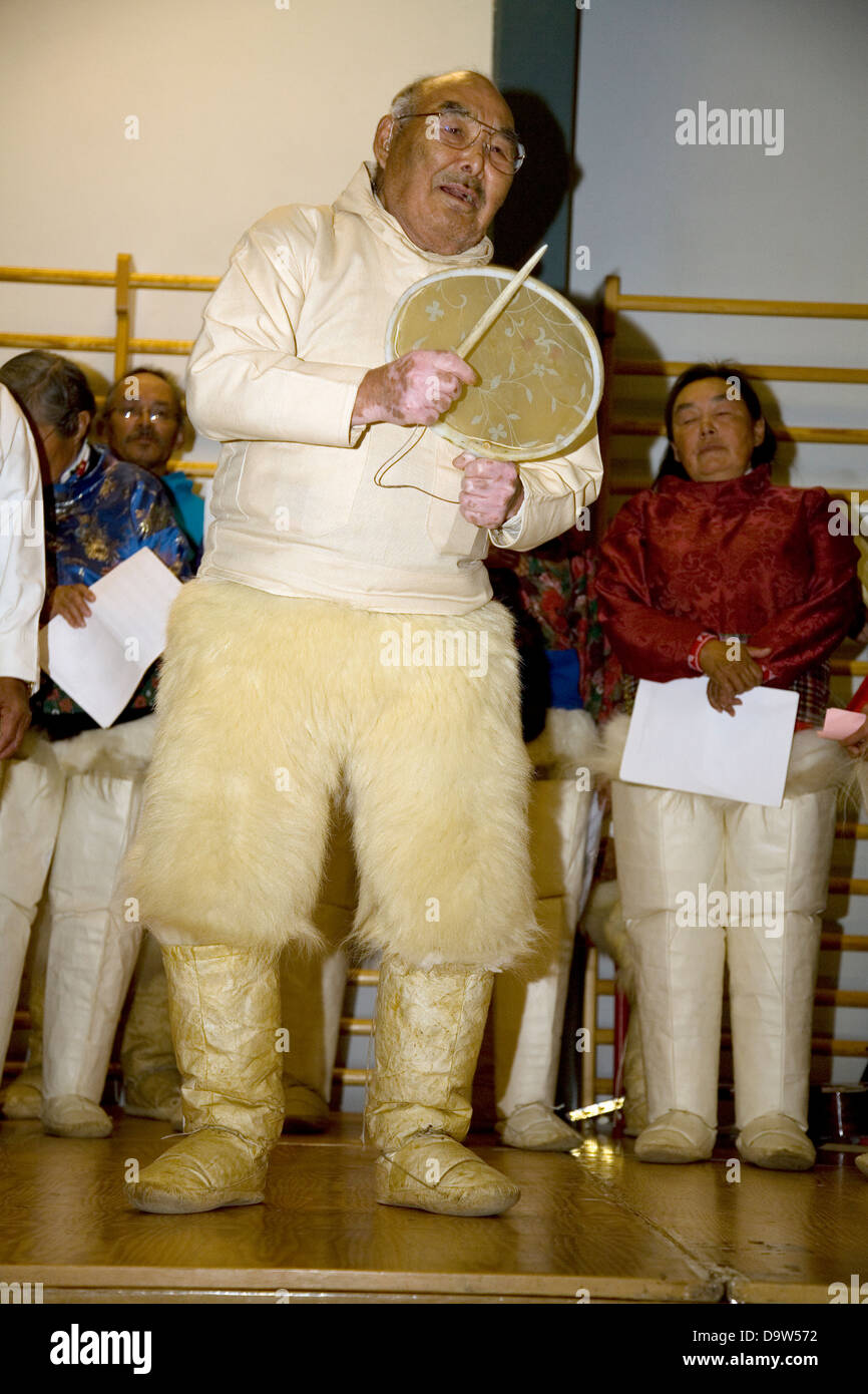Traditional Inuit drum dancing (and choir singing) at the sports hall in Qaanaaq, Greenland Stock Photo