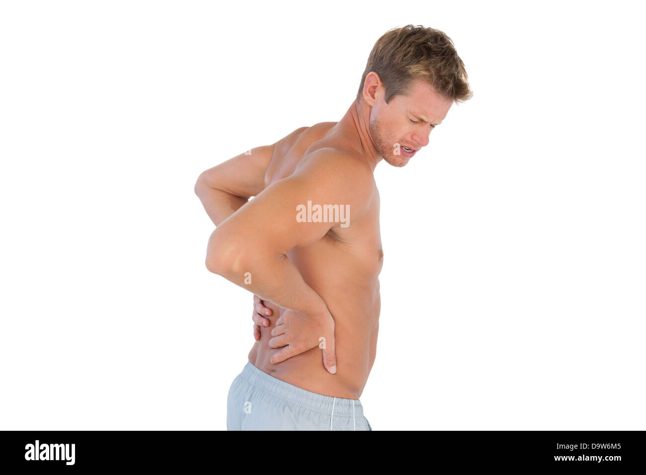 Topless man suffering from back pain Stock Photo