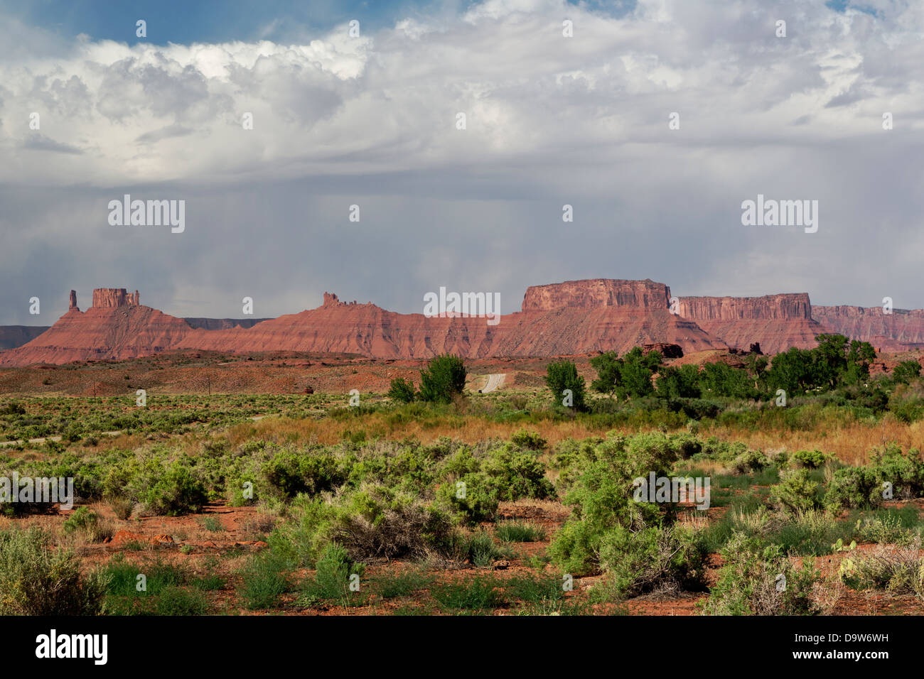 Red sandstone peaks and plateaus of La Sal Mountains with foreground of wild desert. Copy space in blue sky. Stock Photo