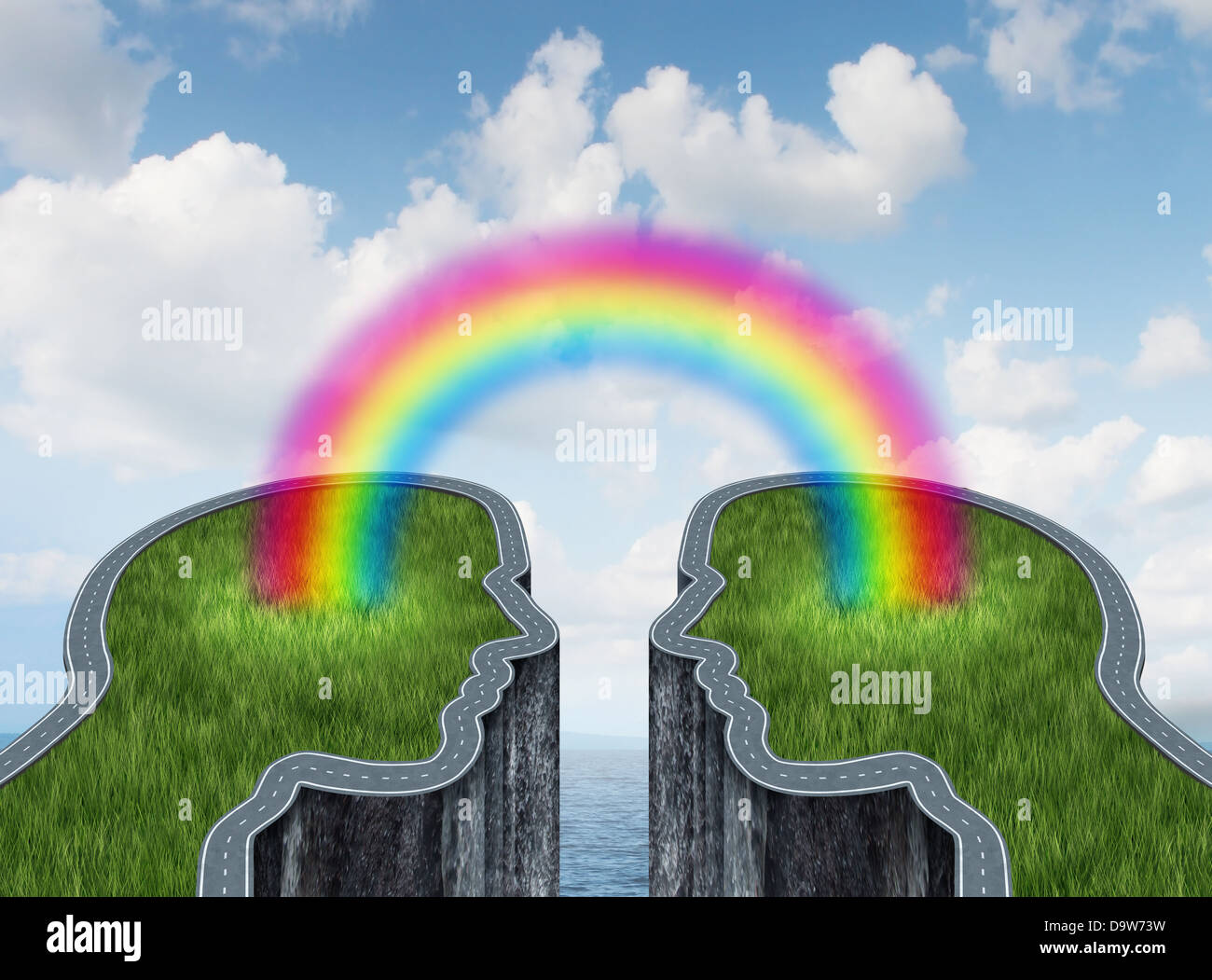 Bridge success concept with two islands and a road or highway shaped as a human head being connected by a bright rainbow as a business symbol of creative cooperation and successful teamwork on a summer ocean sky. Stock Photo