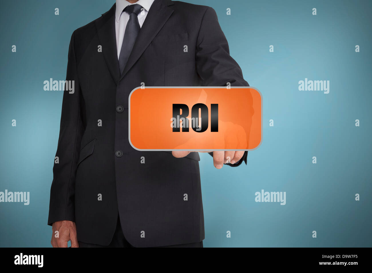 Businessman selecting orange tag with roi Stock Photo