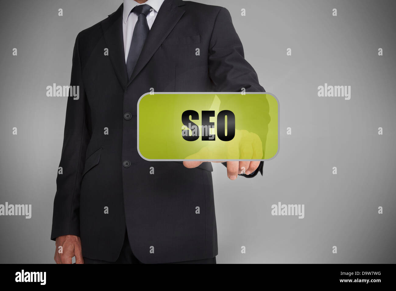 Businessman selecting green tag with the word seo written on it Stock Photo