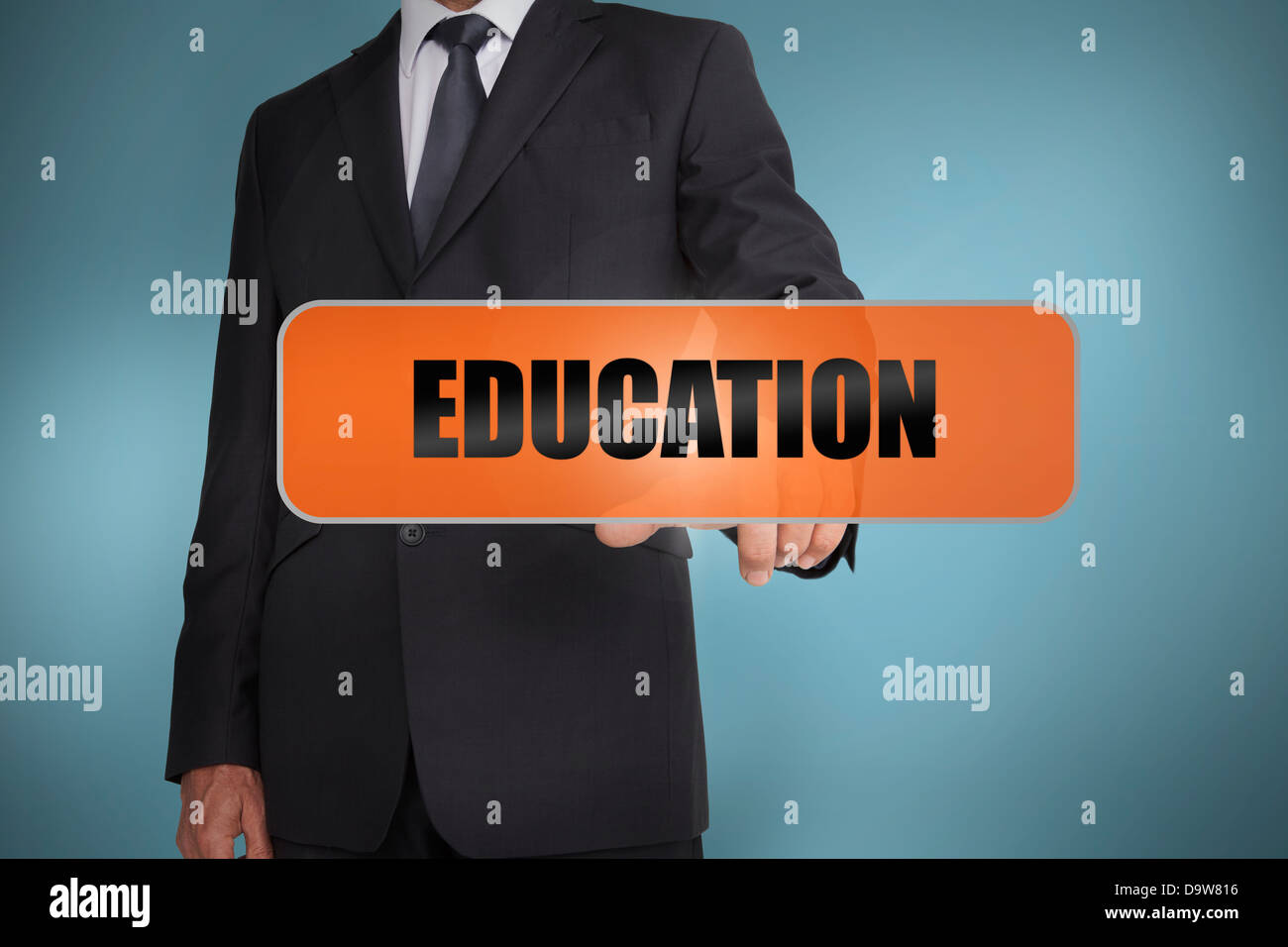 Businessman touching the word education Stock Photo