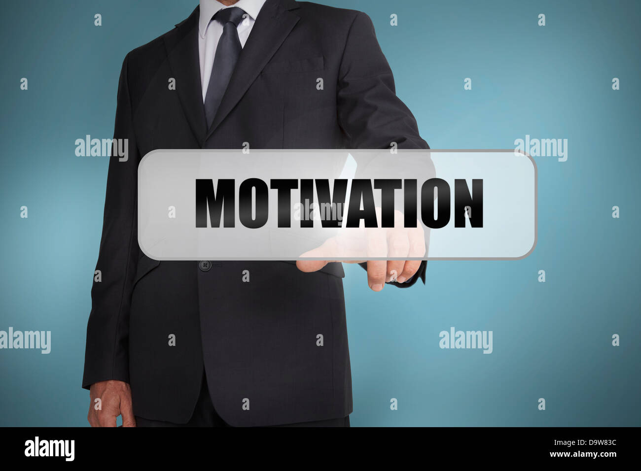 Businessman selecting the word motivation written on white tag Stock Photo