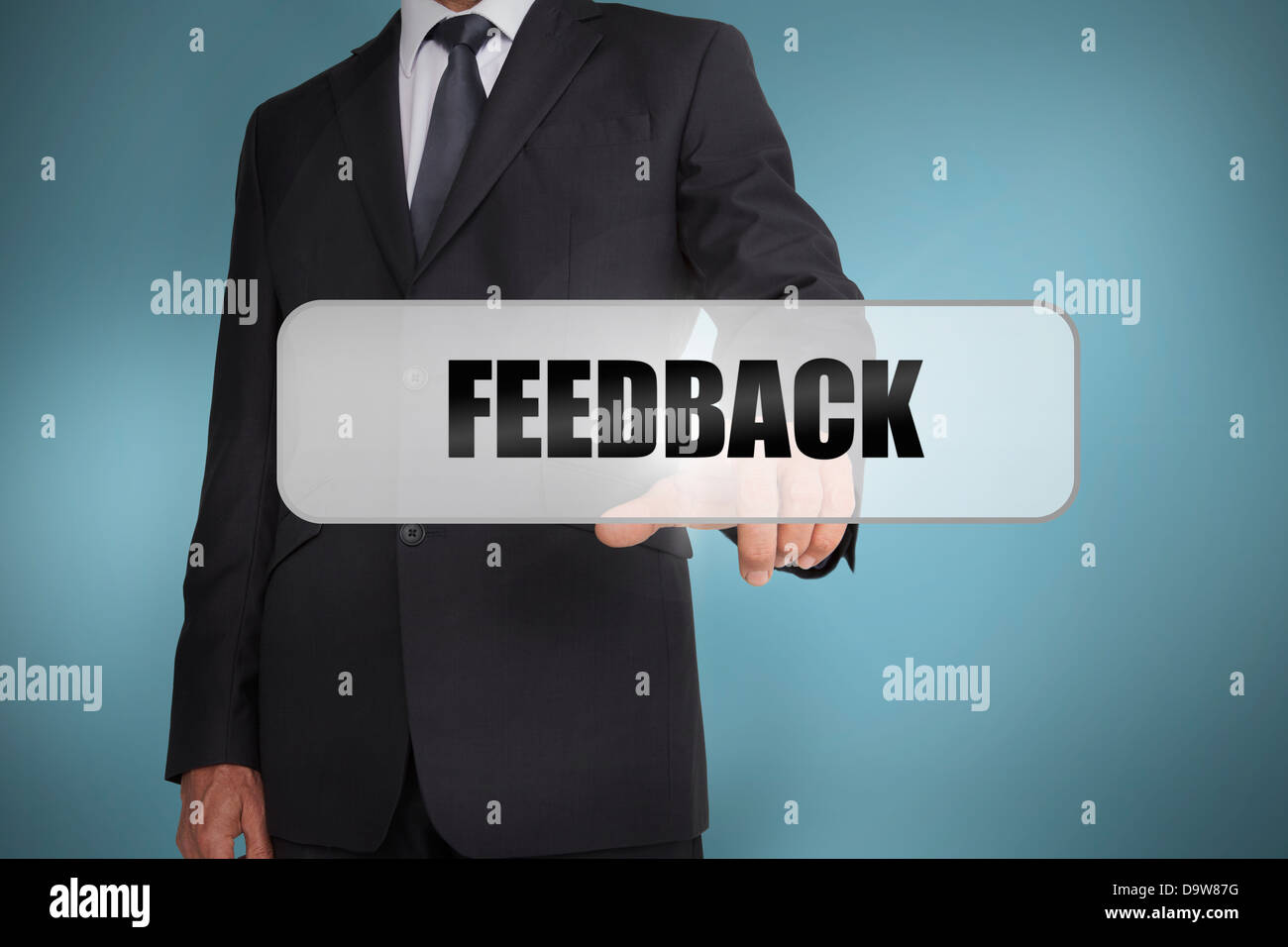 Businessman selecting the word feedback written on white tag Stock Photo