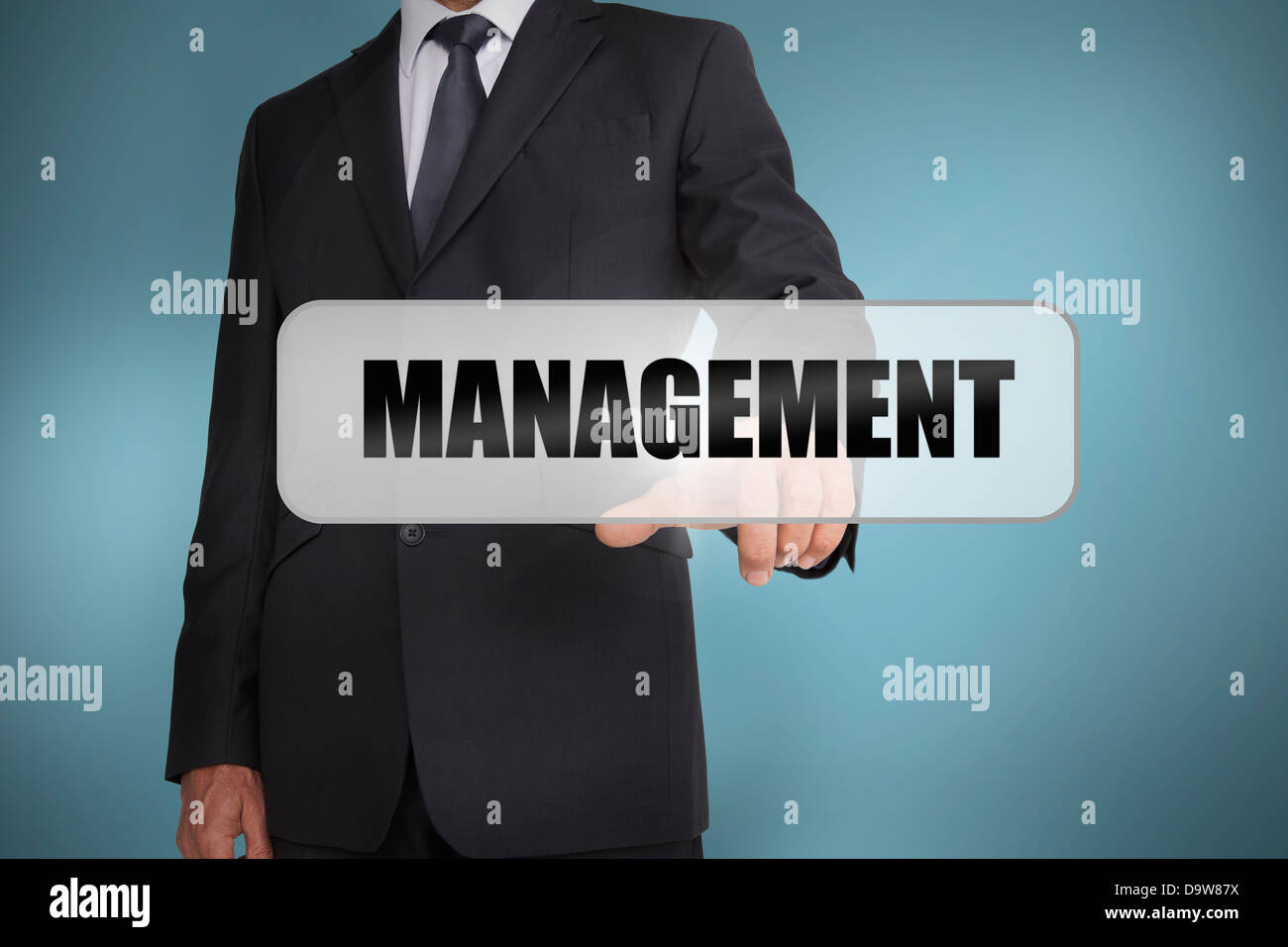 Businessman selecting the word management written on white tag Stock Photo