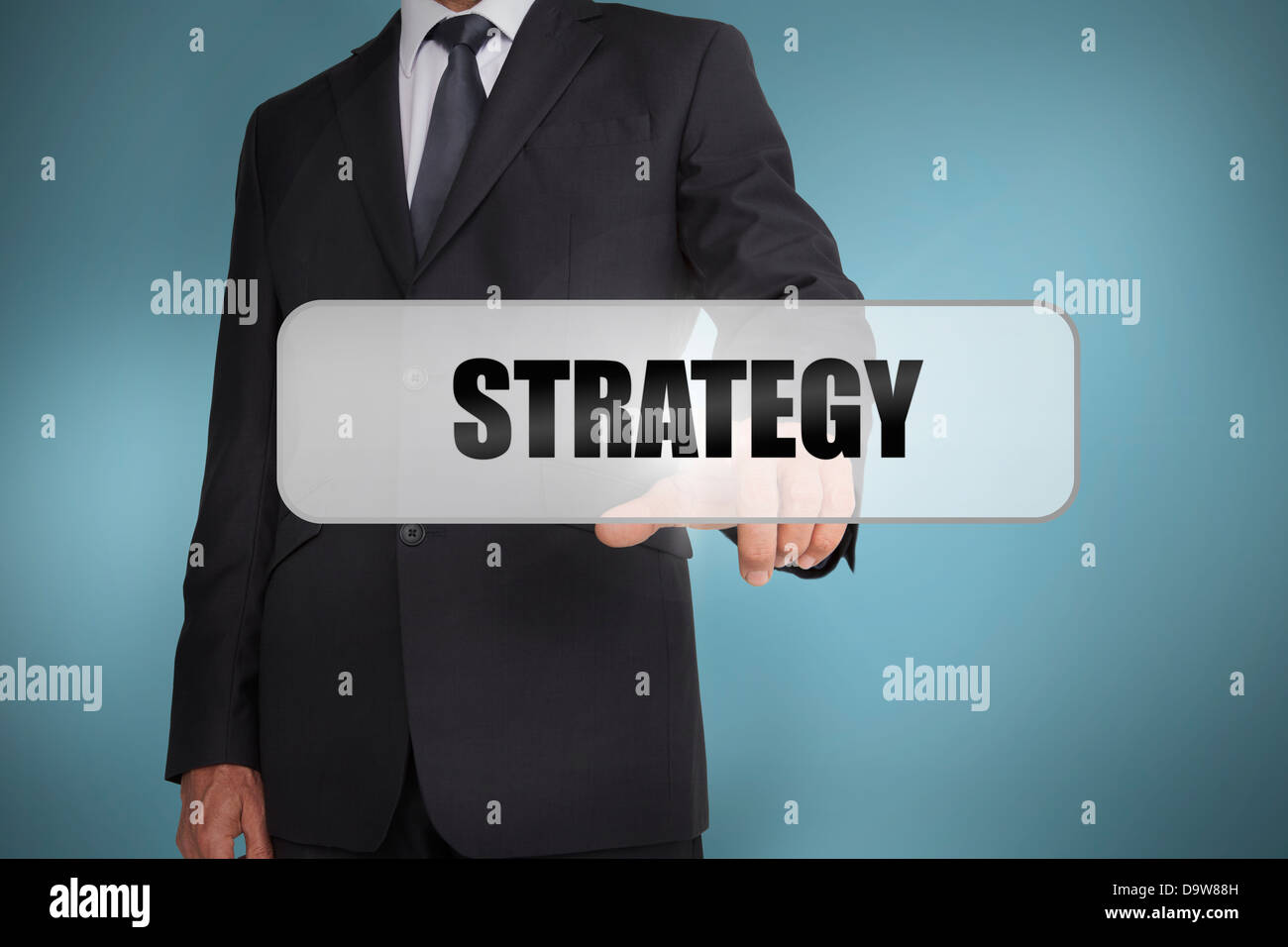 Businessman selecting the word strategy written on white tag Stock Photo