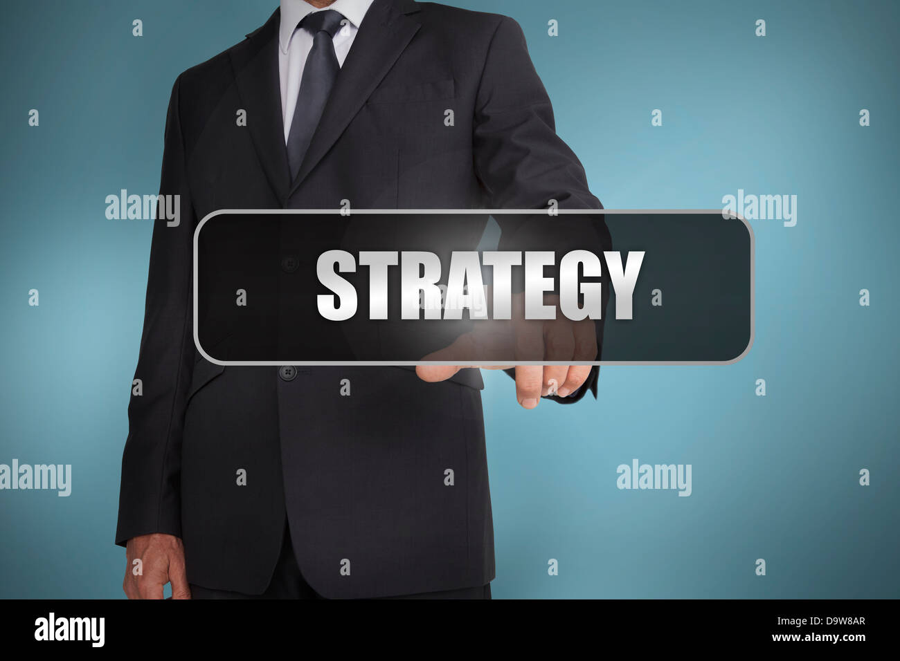 Businessman touching the word strategy written on black tag Stock Photo