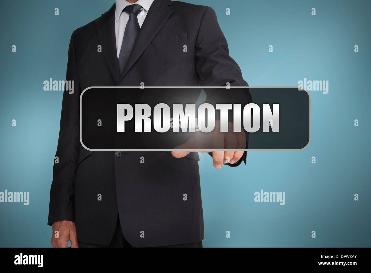 Businessman touching the word promotion written on black tag Stock Photo