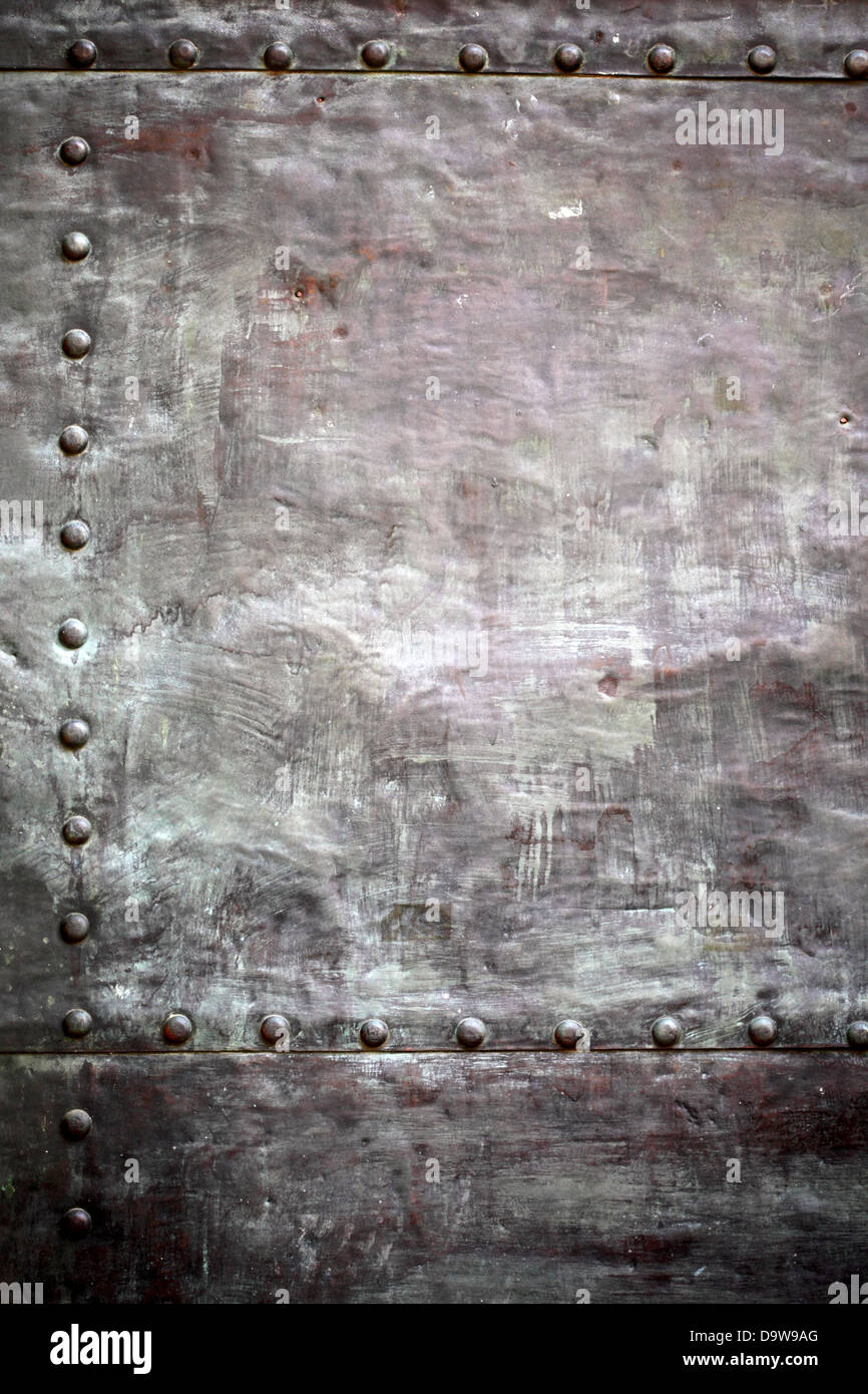 Black grunge metal plate or armour texture with rivets as background ...