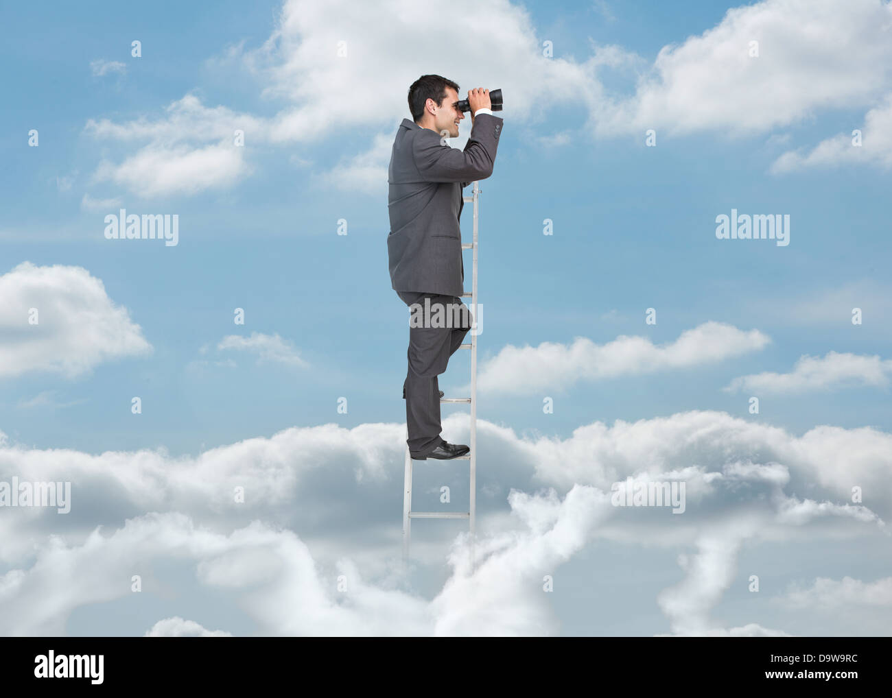Businessman on ladder over the clouds Stock Photo