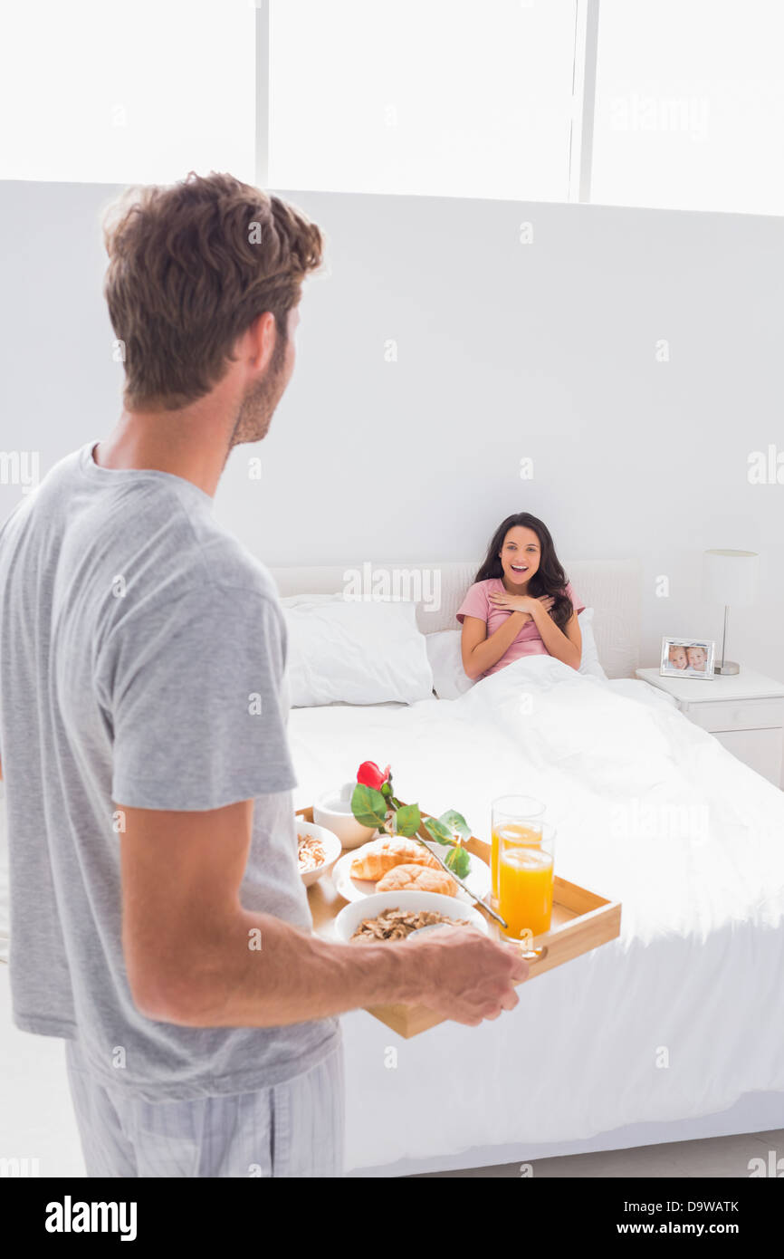 Man bringing breakfast to his surprised wife Stock Photo