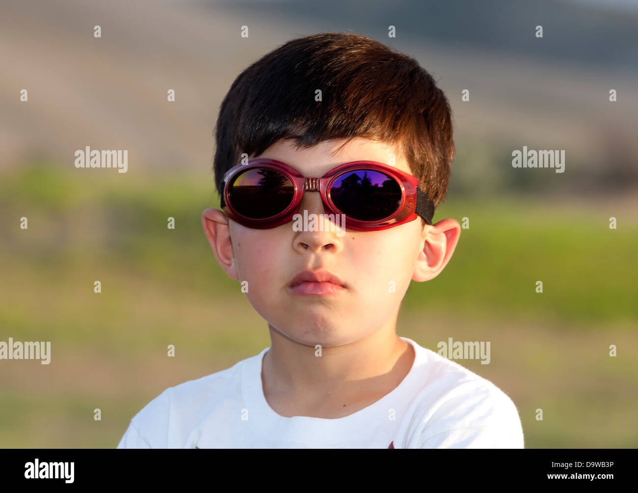Boy wears colored goggles. Stock Photo