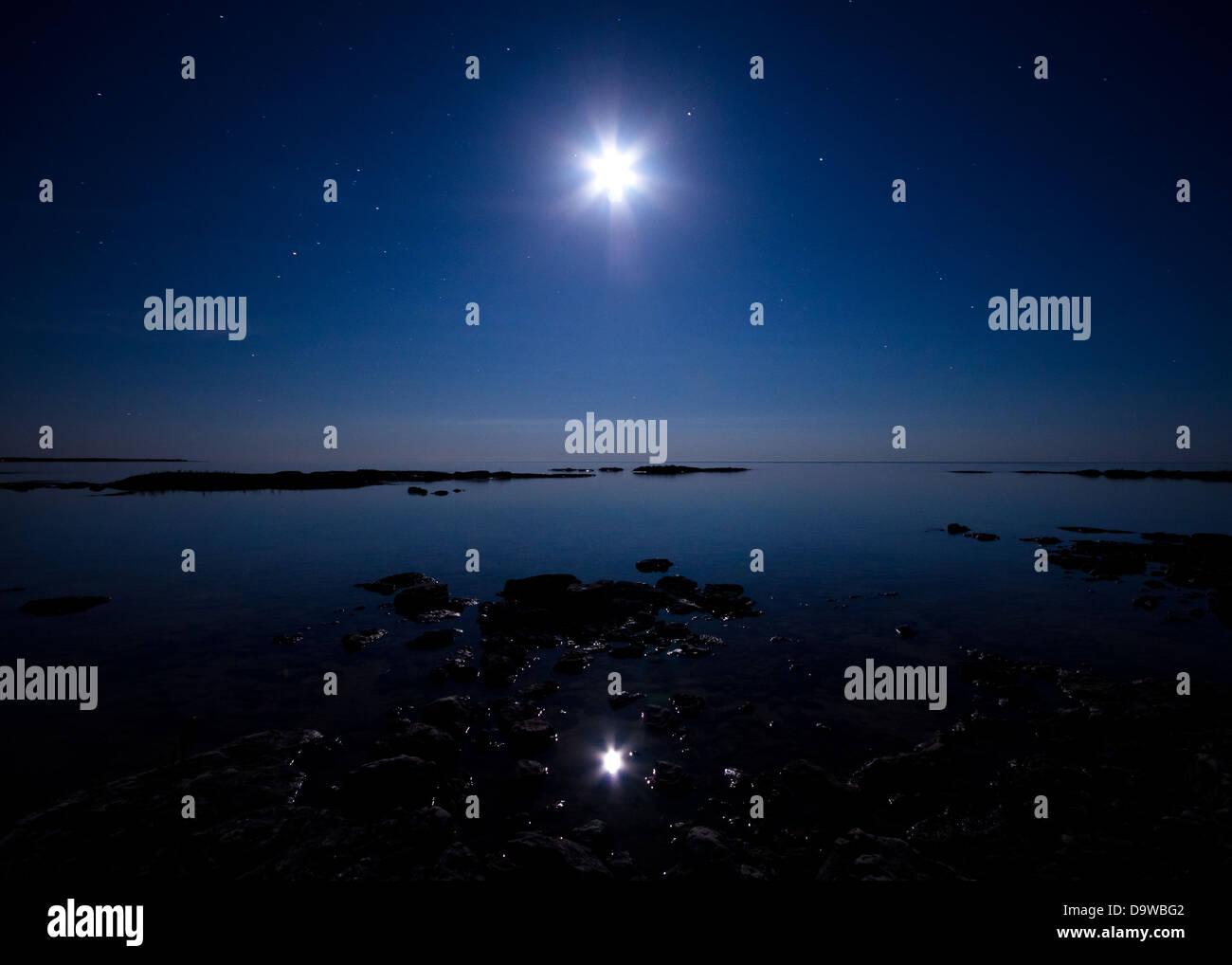 The full moon reflecting over Lake Huron near Tobermory, Ontario, Canada. Stock Photo
