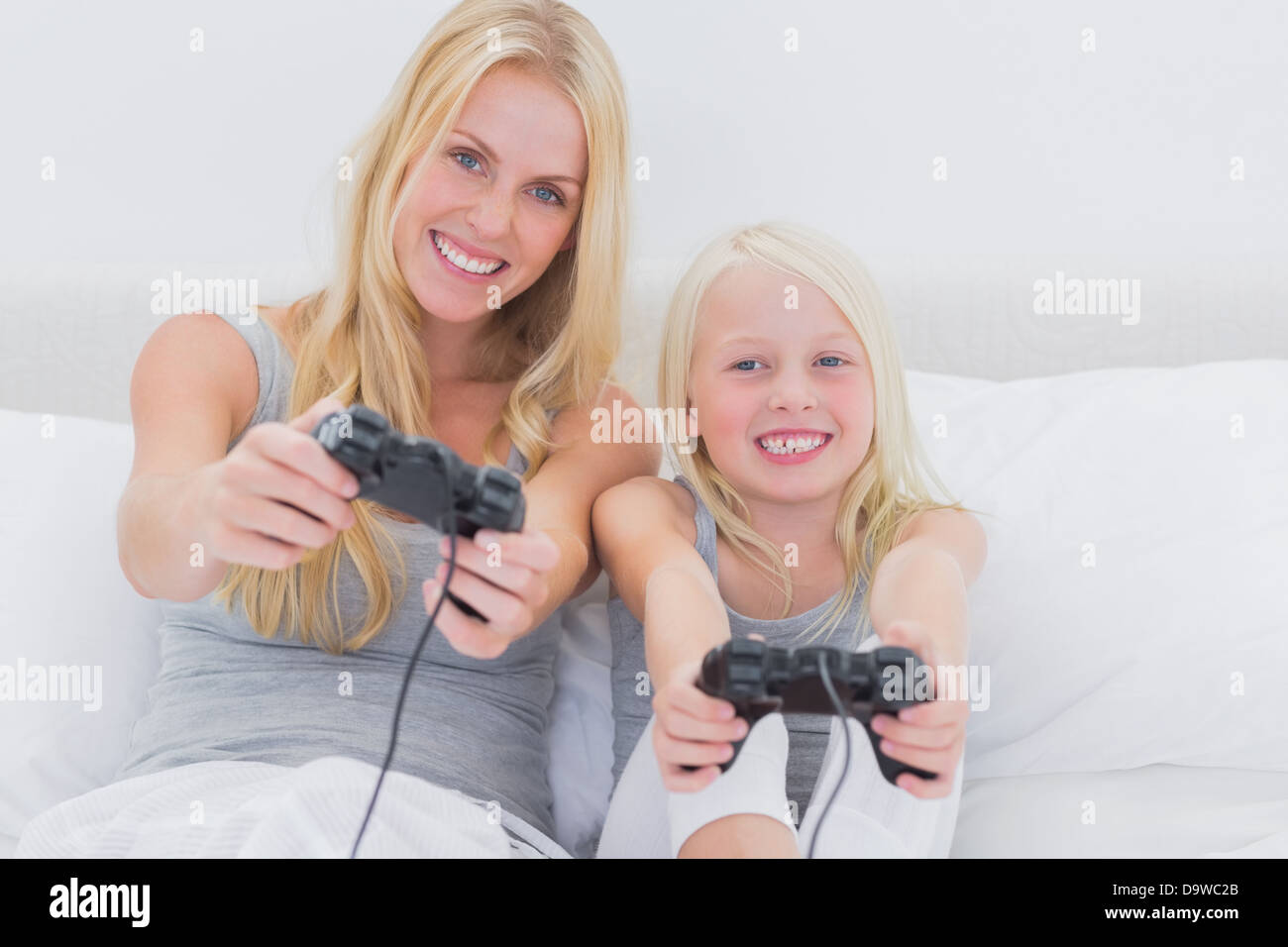 Mother and daughter playing video games Stock Photo