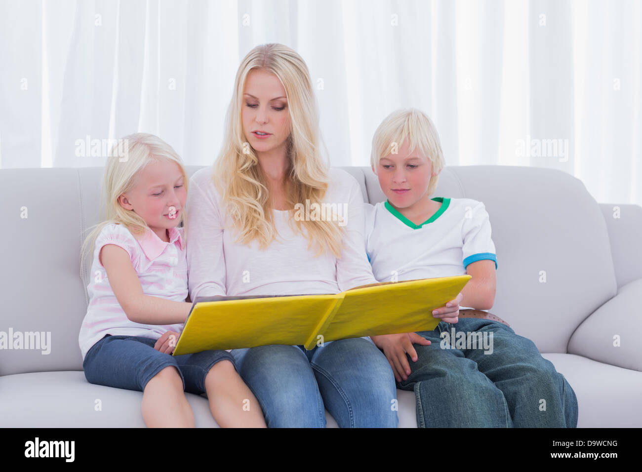 Mother reading a story to children Stock Photo