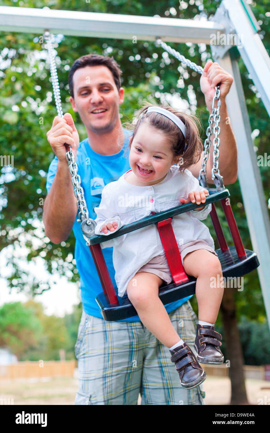 2 and a half year old girl with Down's syndrome with her father Stock