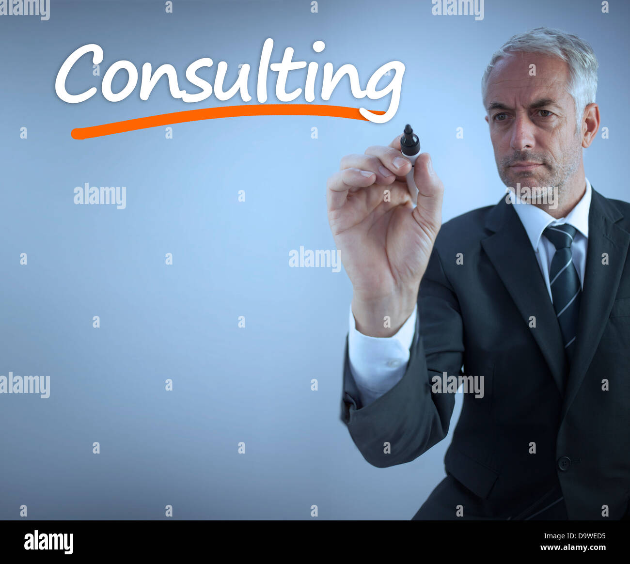 Businessman writing the word consulting Stock Photo