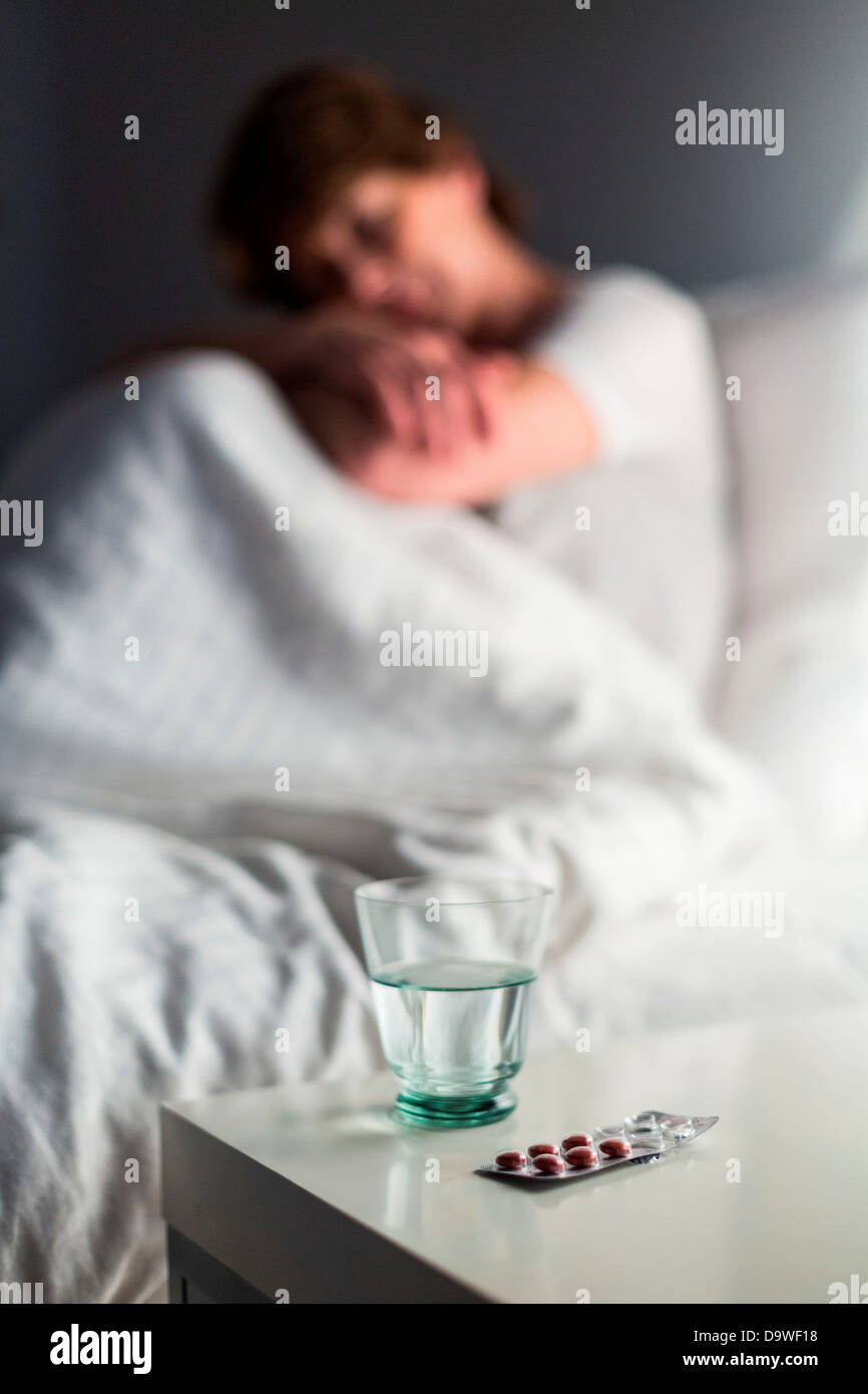 Restless woman sits up in bed unable to sleep Stock Photo Alamy