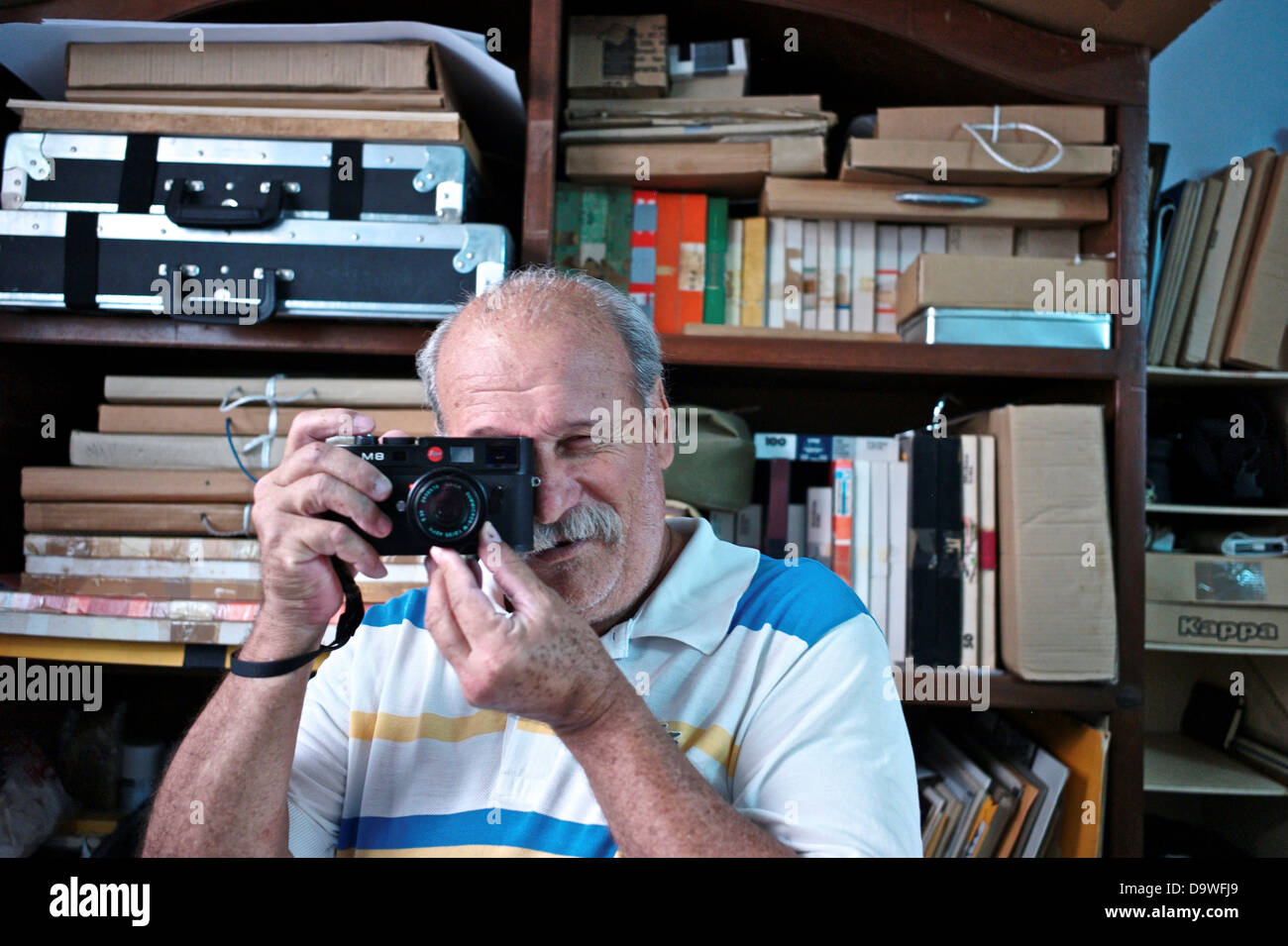 Cuba, Havana, Photographer holding his Leica Camera M8 at his home Stock Photo