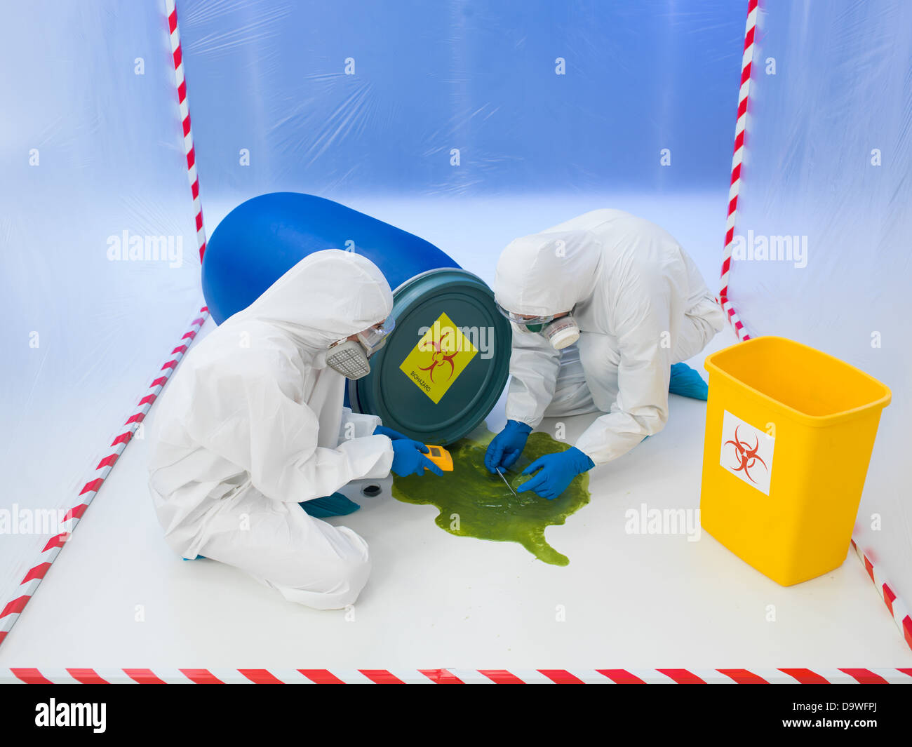 Two scientists in full protective biohazard suits attending to a biohazard chemical spill of