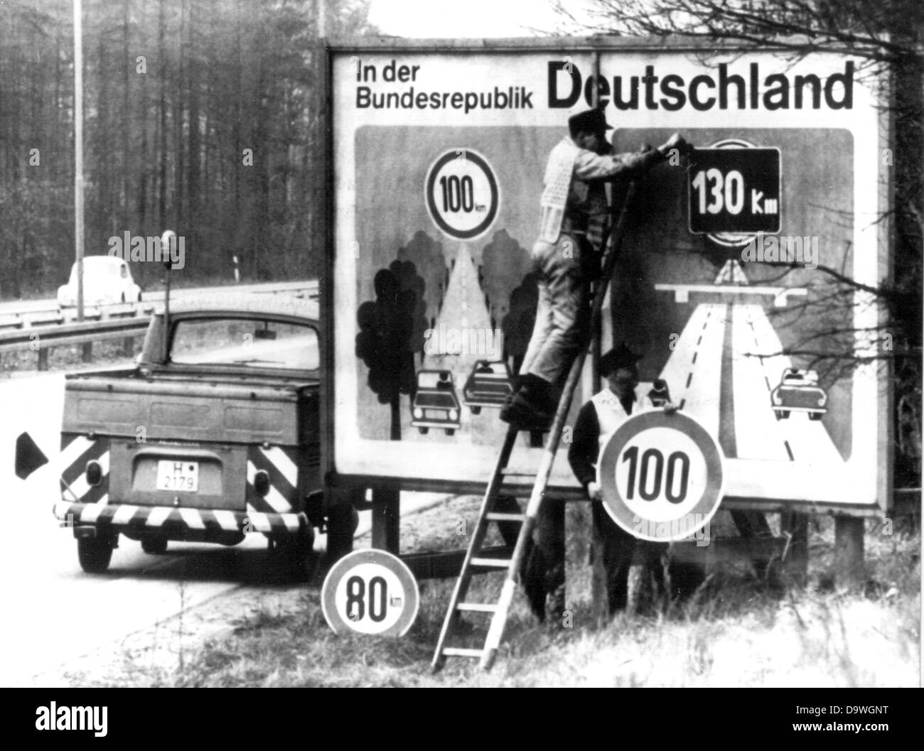 Employees of the motorway maintenance authorities put up signs reminding of the advisory speed limit of 130 on the 14th of March in 1974. Stock Photo