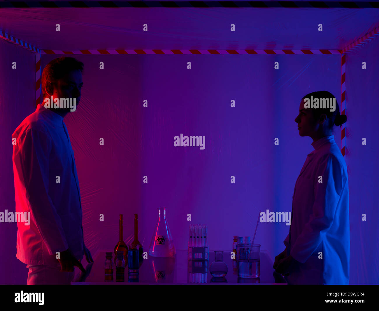 two persons, a man and a woman, standing opposite from each other next ...