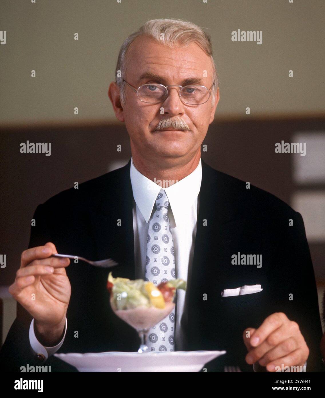 Vicco von Bülow shows how to behave at the table in a scene of the TV show 'Telecabinet' in August 1974. The writer, author and caricaturist Vicco von Bülow alias Loriot already became popular in the 1950s. He celebrates his 80th birthday on the 12th of November in 2003. Stock Photo