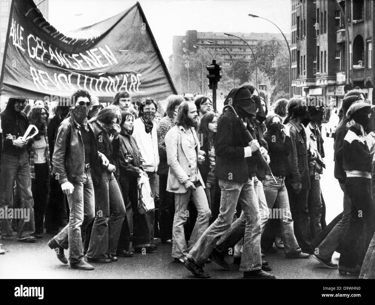 A group of about 4,500 partly hooded demonstrators marches through Berlin after Ulrike Meinhof's funeral on the 15th of May in 1976. The arrested RAF terrorist Ulrike Meinhof had committed suicide in her cell in Stuttgart-Stammheim on the 5th of May in 1976 and was buried on the 15th of May in 1976 in Berlin. Stock Photo