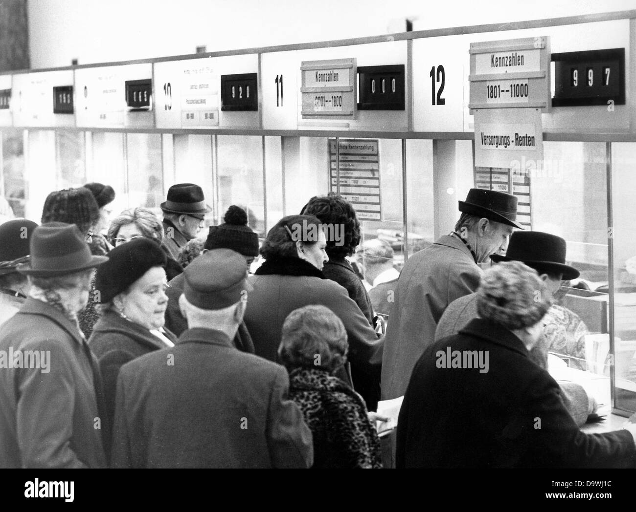 Pensioners queue in front of the cashier's desk in the main post office in Frankfurt am Main in March 1972. Stock Photo