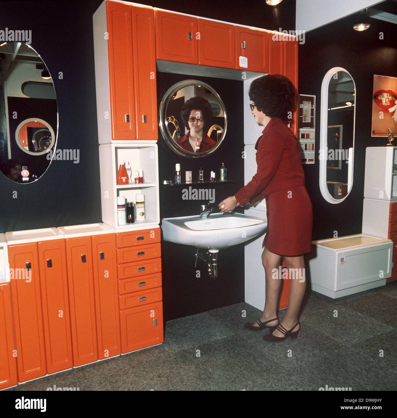 A modern bath room in orange is presented at the German Furniture Fair