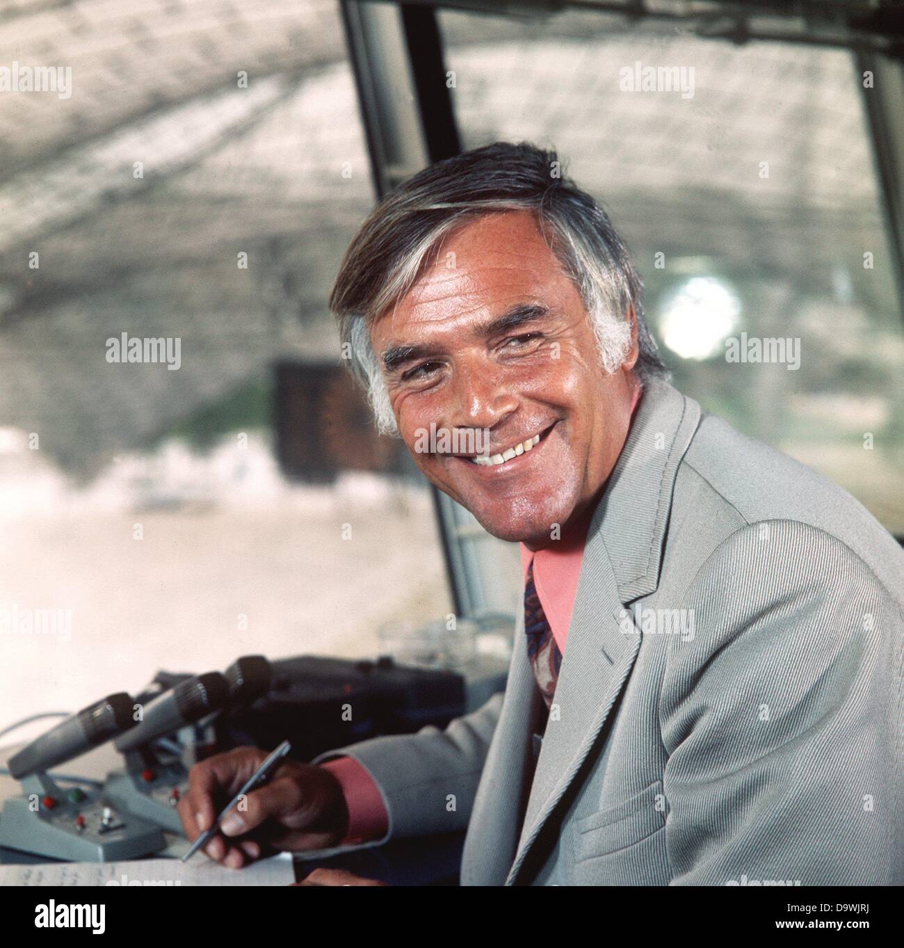 Actor Joachim Fuchsberger sits in the commentator's booth in the Olympia stadium in Munich in 1972. He will be the stadium announcer during the Olympic Games. Stock Photo