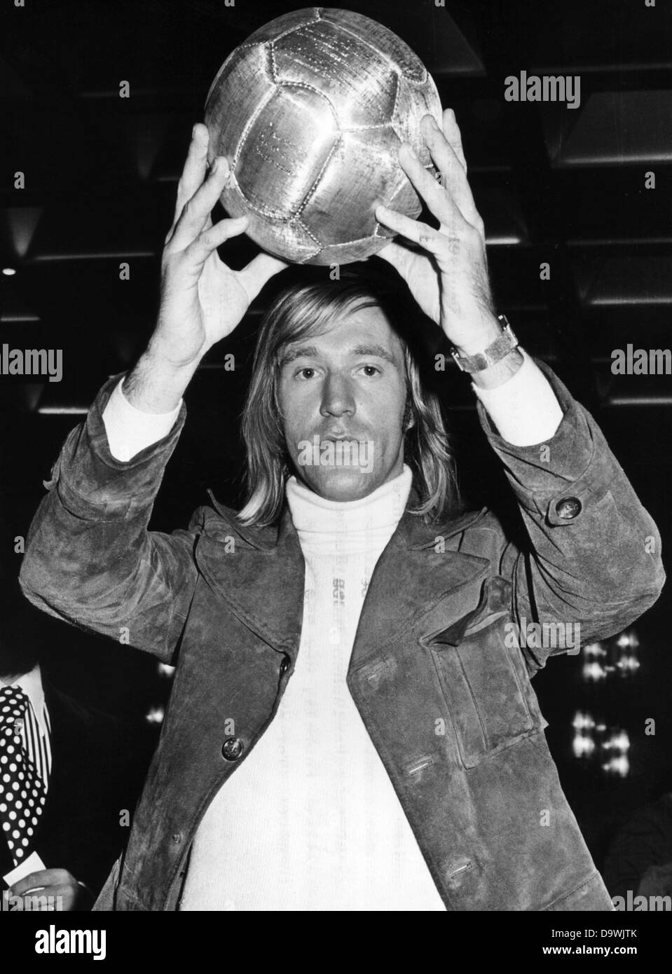 Germany's 'Soccer player of the Year 1972', Günter Netzer, holds up the 'Golden Football', which was awarded to Brazilian soccer star Pele in 1969 for his 1000th goal. Stock Photo