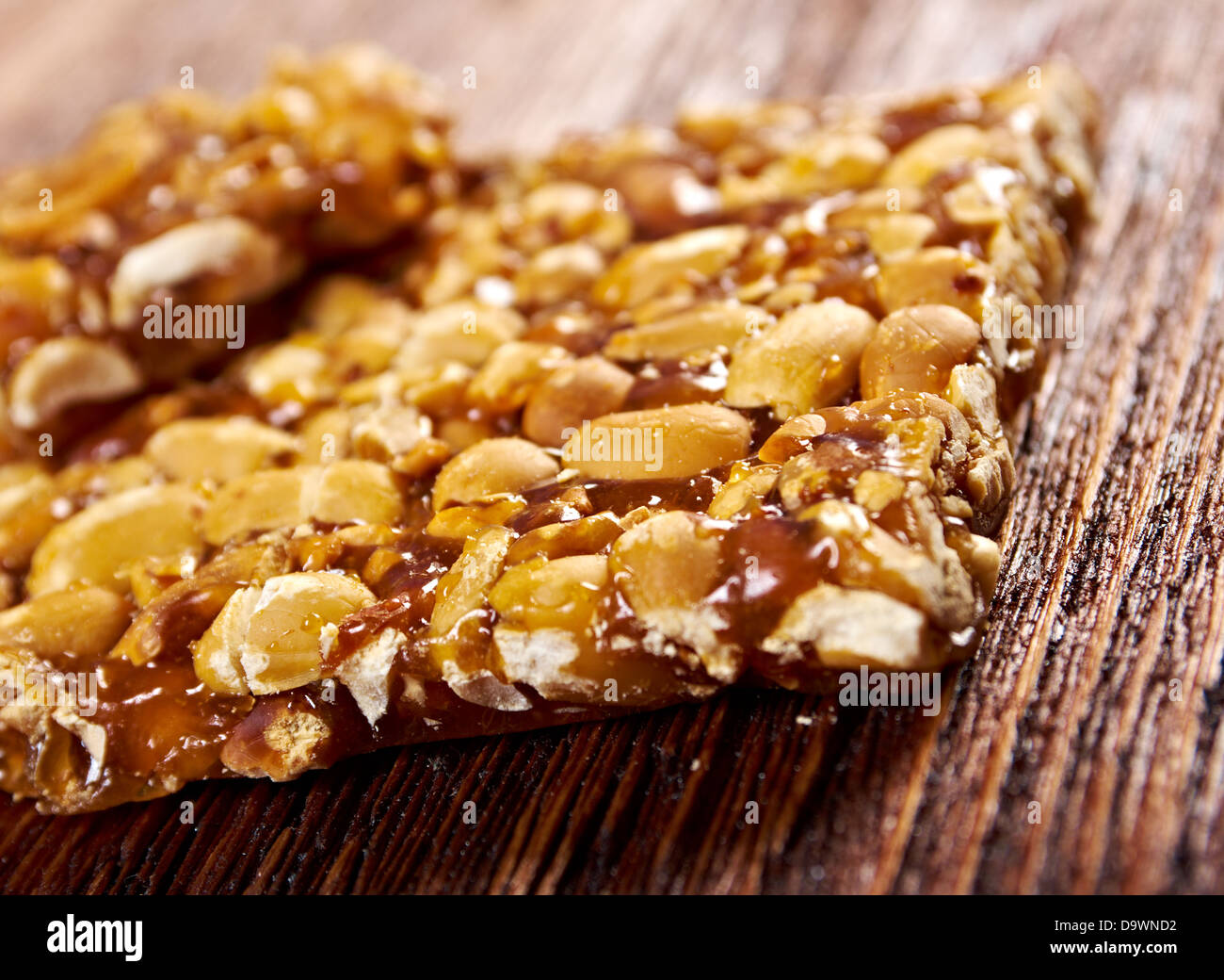 Peanut brittle sweet hard on wooden table Stock Photo Alamy