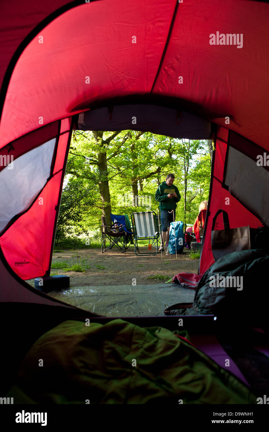 Man camping seen through tent Stock Photo