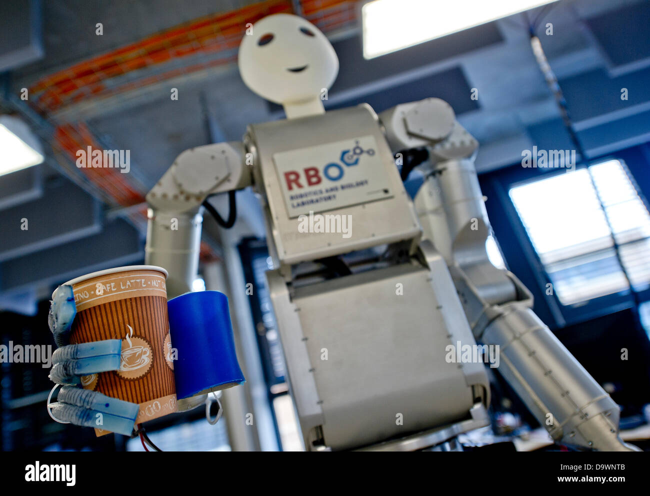 Robot 'Meka' manufactured by 'Meka Robotics' holds a cup of coffee at the Technische Universitaet (TU) in Berlin, Germany, 27 June 2013. The 'Softhands' or 'RBO Hand' have been developed by the Robotics and Biology (RBO) Laboratory of the TU Berlin. Photo: Nicolas Armer Stock Photo