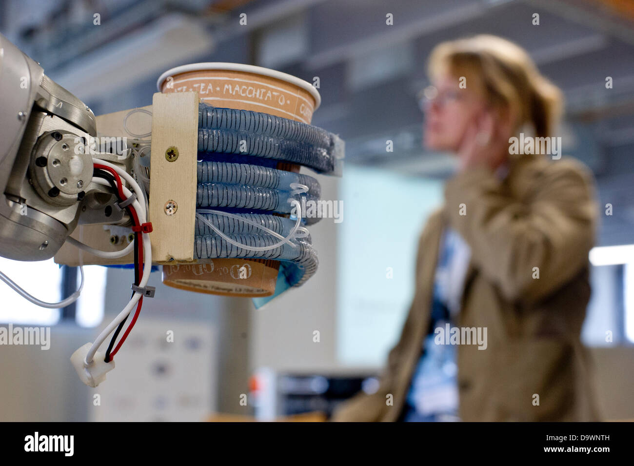 Robot 'Meka' manufactured by 'Meka Robotics' holds a cup of coffee at the Technische Universitaet (TU) in Berlin, Germany, 27 June 2013. The 'Softhands' or 'RBO Hand' have been developed by the Robotics and Biology (RBO) Laboratory of the TU Berlin. Photo: Nicolas Armer Stock Photo