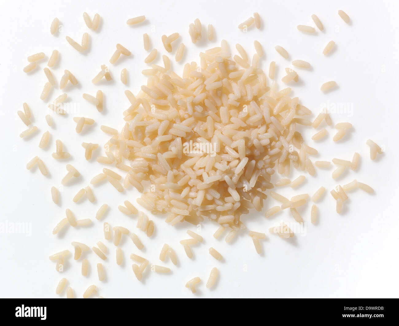 Brown rice on white surface Stock Photo