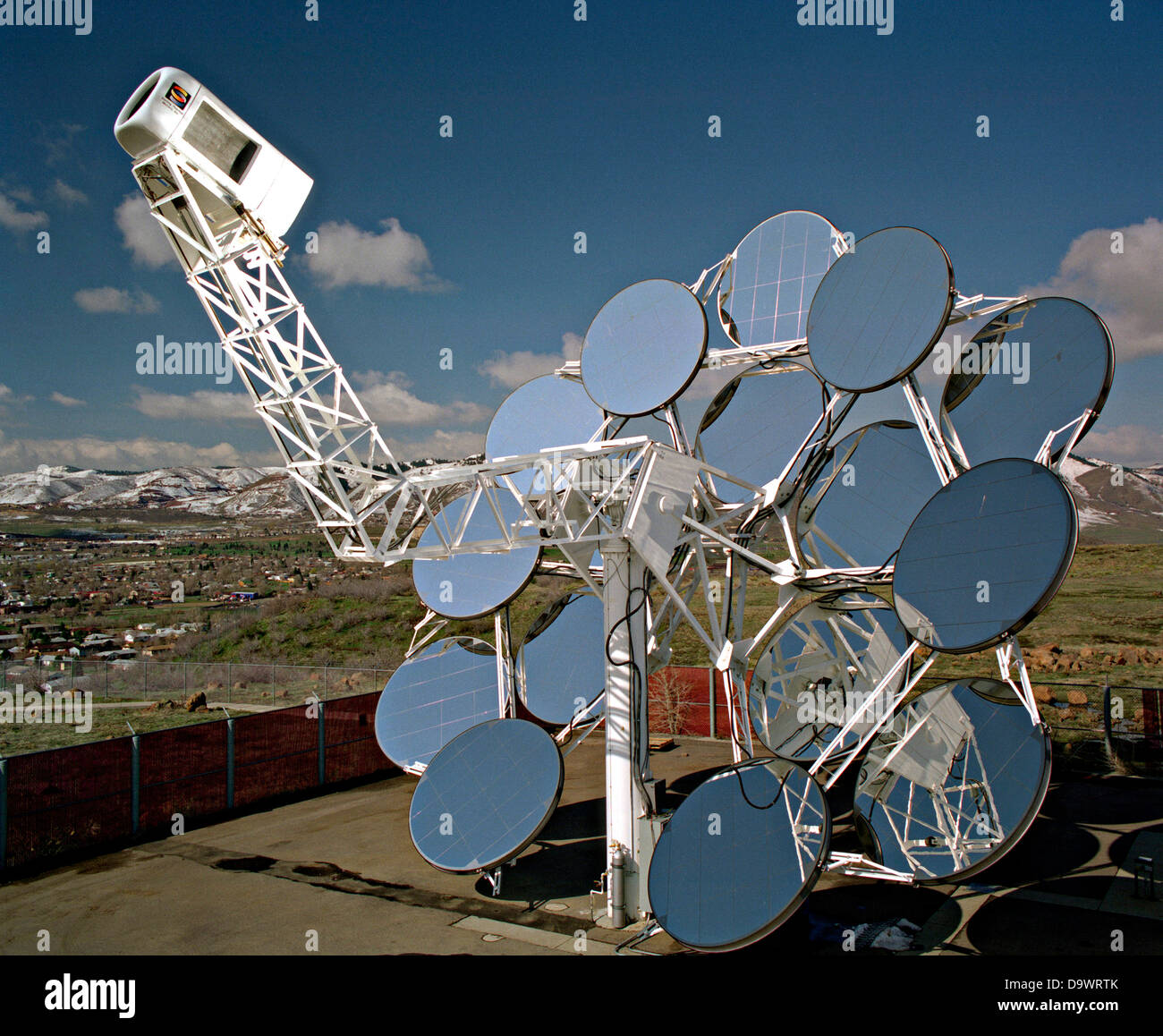 Stirling Solar power systems solar dish engine April 21, 1998 in Golden, Colorado. The dish produces electricity uses mirrors to focus sunlight onto a thermal receiver. The heat is used to run a Stirling heat engine, which drives an electric generator. Stock Photo