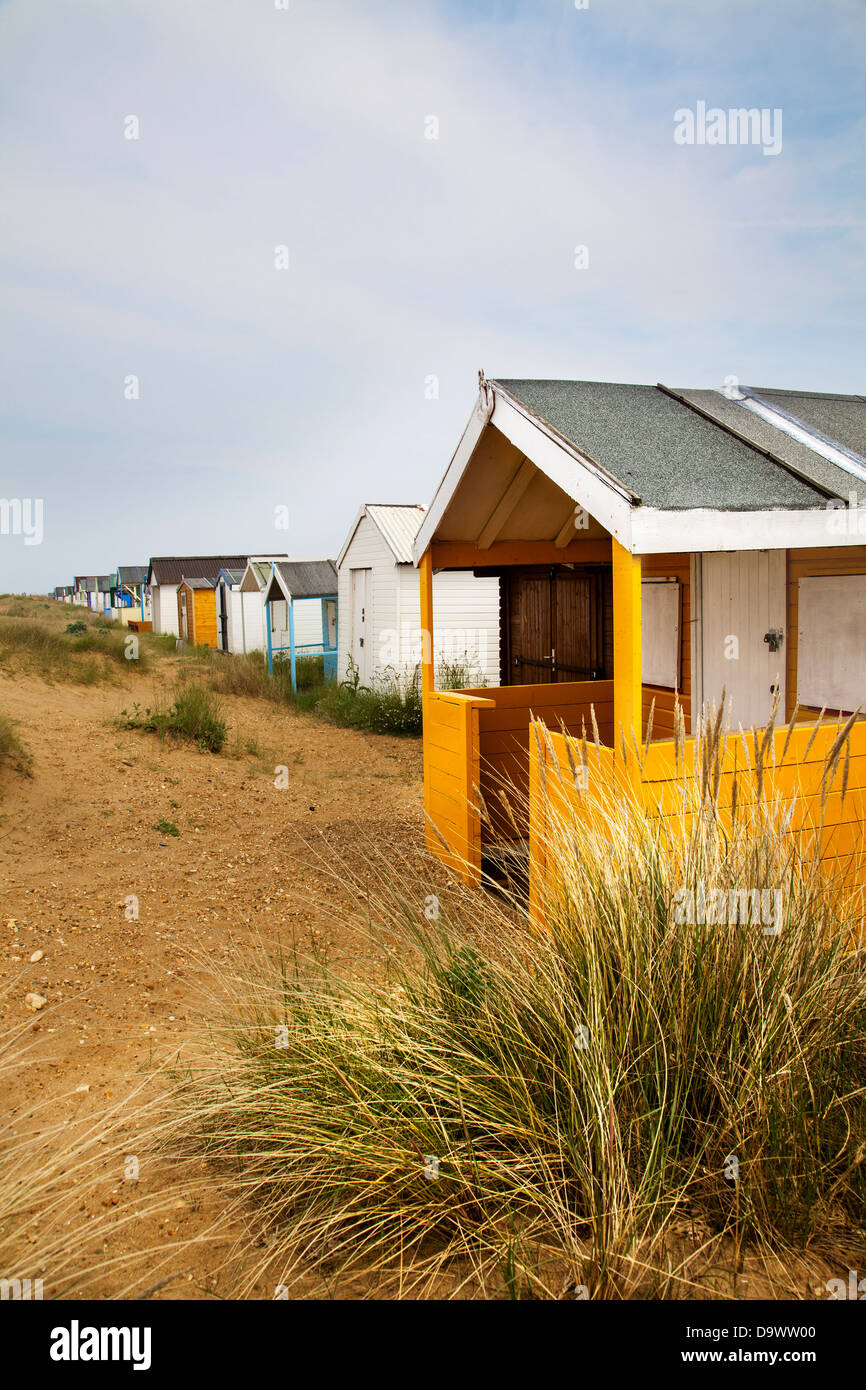 Wood panelled painted changing huts on sandy Heacham North Beach