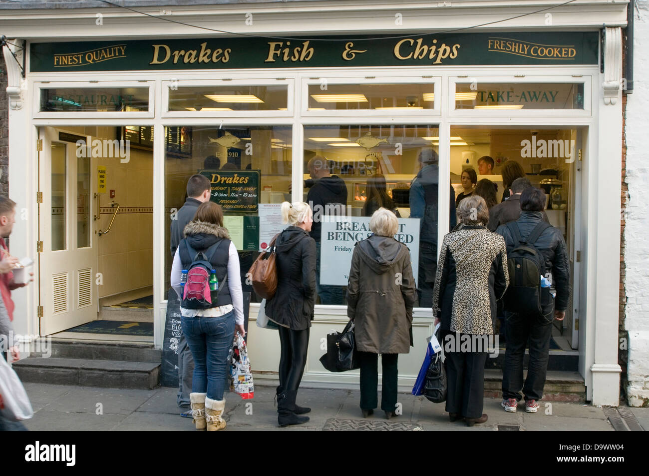 fish and chip chips shop shops que ques outside people queuing customers demand traditional english fast food n uk Stock Photo