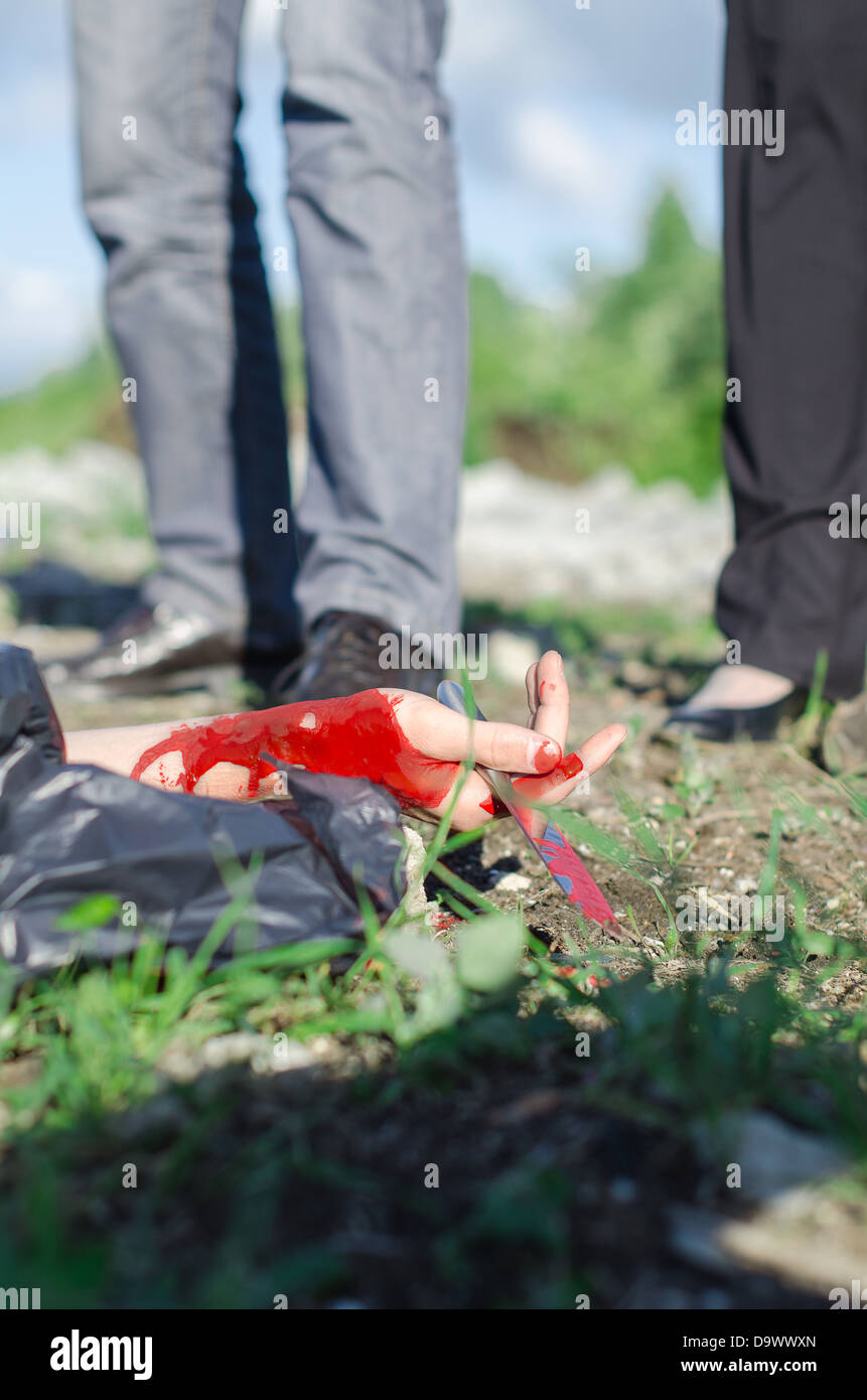 Close up view of bloody hand with knife Stock Photo