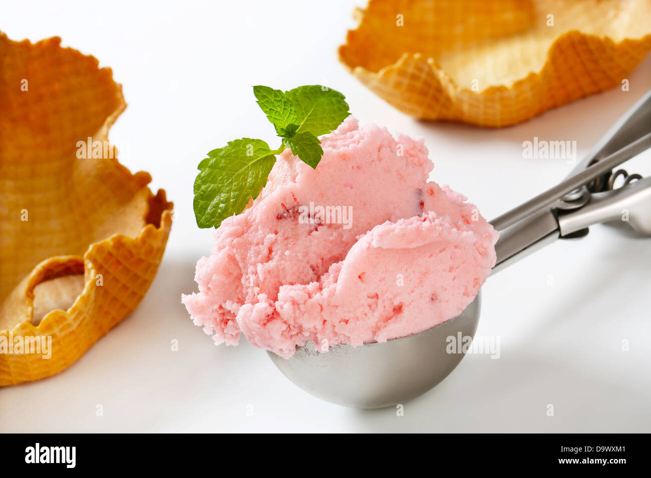 Scoop of pink ice cream and waffle baskets - still life Stock Photo