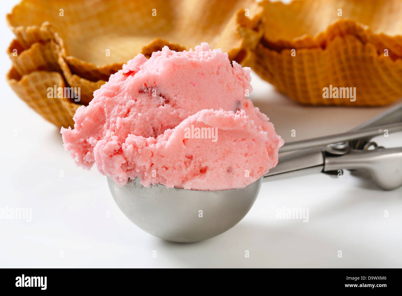 Scoop of pink ice cream and waffle baskets - still life Stock Photo