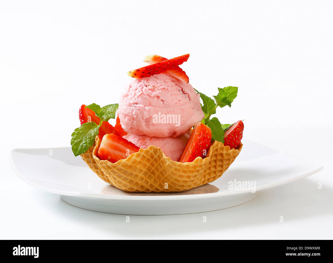 Scoops of strawberry ice cream in waffle basket Stock Photo