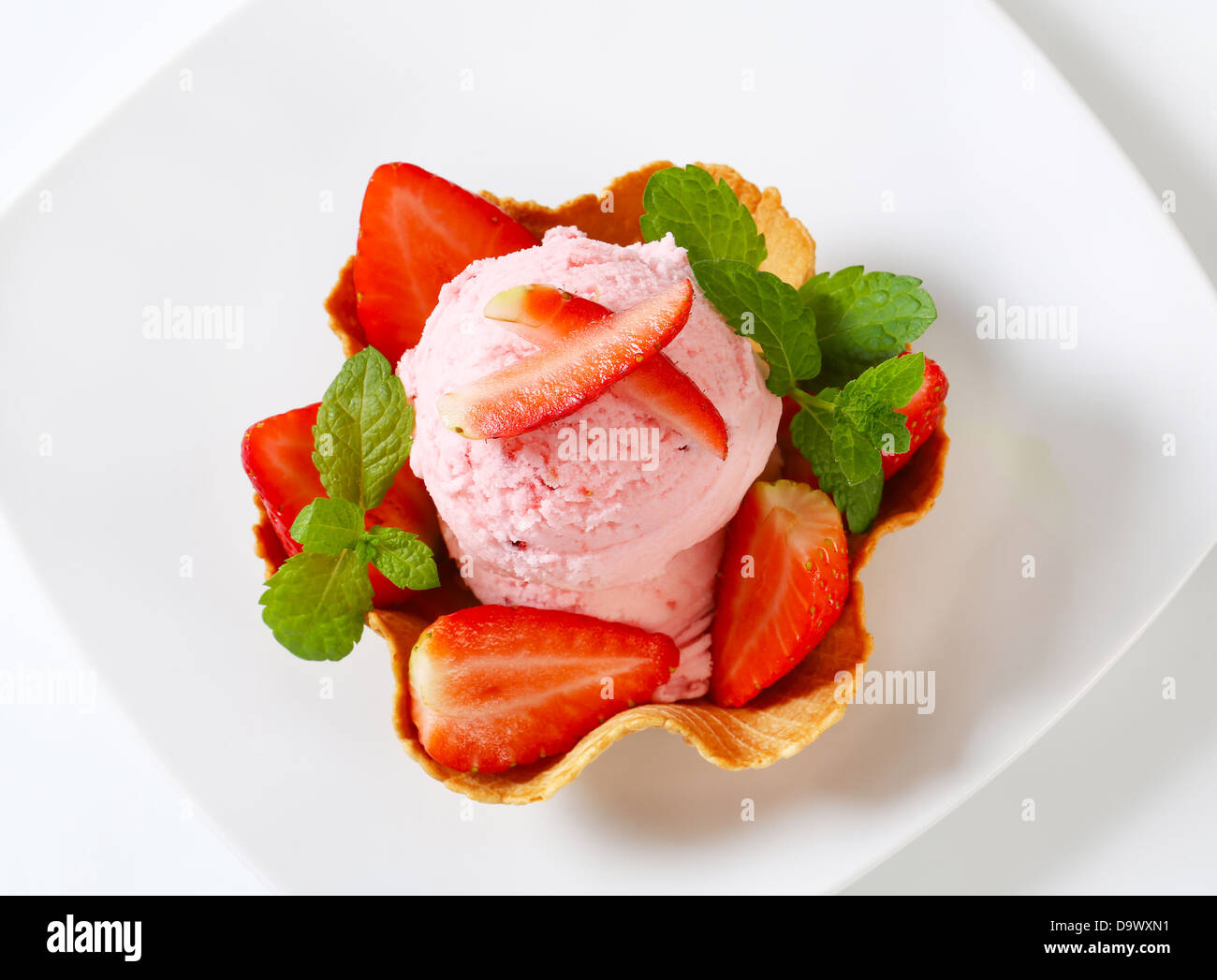Scoops of strawberry ice cream in waffle basket Stock Photo