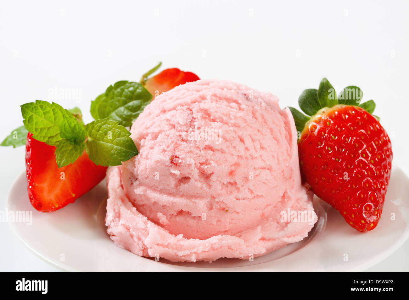 Scoop of ice cream with fresh strawberries Stock Photo