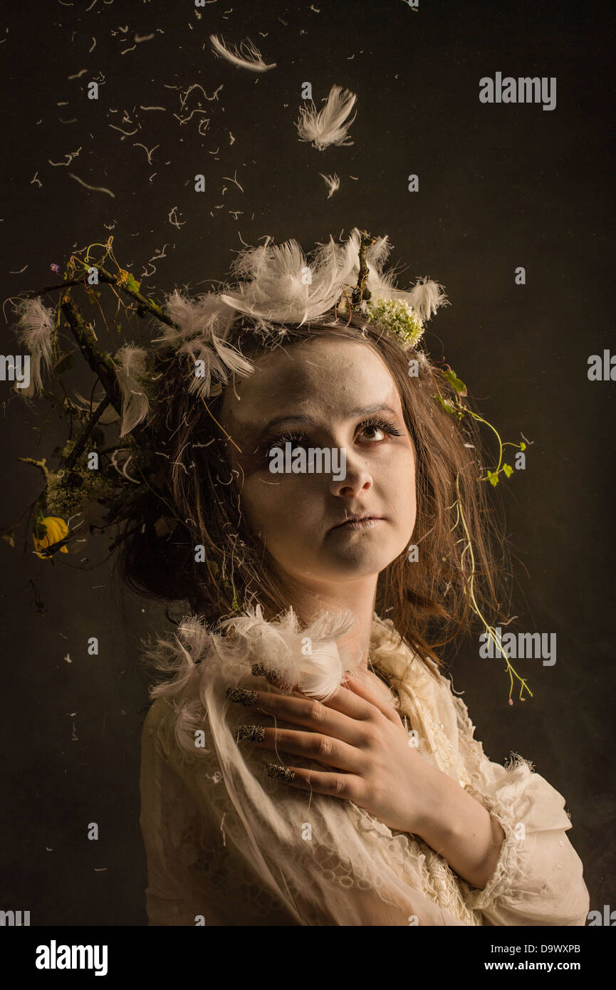 A fantasy makeover photo session - woman girl dressed as pale ghostly woodland spirit creature Stock Photo