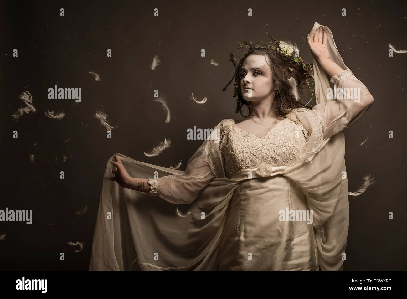 A fantasy makeover photo session - woman girl dressed as pale ghostly woodland spirit creature Stock Photo